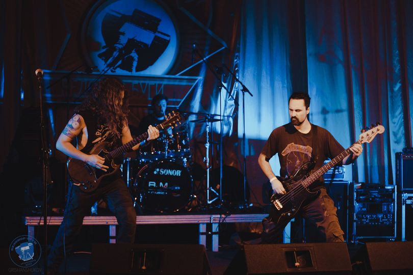 A band performing on stage in front of a crowd.