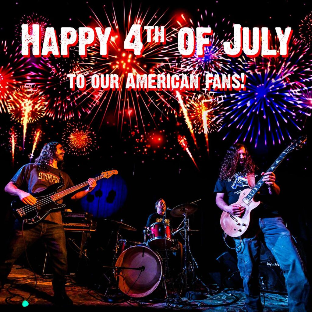 A band playing in front of fireworks and the american flag.