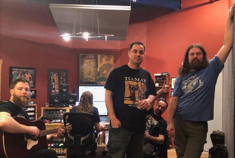 Two men standing next to a skull pile.
